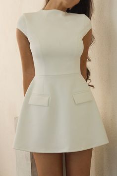 Meet our fabulous Cote Dress - a white cap sleeve mini dress crafted with a premium knit fabric, the fitted bodice effortless sculpts to the bodies natural curves with a slight shaping effect at the hips providing the LEAU fit we are known for. The dress slips down to a mini length and is accompanied by faux pockets at the hips for a classic yet elegant dress you will keep in your wardrobe for years to come. Fitted A-line Mini Dress With Structured Shoulders, Chic A-line Mini Dress With Structured Shoulders, Elegant Mini Dress With Structured Shoulders And Short Sleeves, Classic Mini Dress With Flattering Silhouette, Elegant White Mini Dress With Structured Shoulders, White Mini Dress With Flattering Silhouette, Fitted White Mini Dress With Cap Sleeves, White Fitted Mini Dress With Structured Shoulders, White Fitted Mini Dress With Cap Sleeves