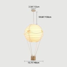 a white light bulb with measurements for the size and shape of it, on a gray background