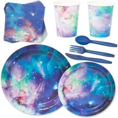 a set of space themed plates, cups and utensils with napkins on them