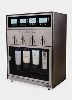 a wine dispenser is shown with three bottles in front of the machine