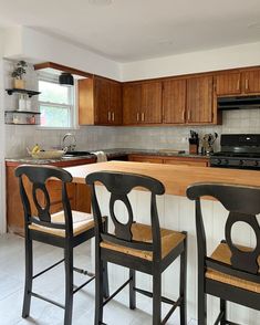 two chairs sitting in front of a kitchen counter