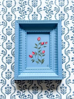 a blue frame with flowers painted on it