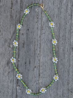 The daisy chain is making a comeback with bright colors. You can order the necklace customized from me and specify your color preferences for the necklace and the individual daisies. Each necklace is made with great attention to detail and has a clasp. Avoid wearing it underwater for long periods of time. All orders are hand-packed and shipped within one week. I'm looking forward to bringing you good cheer through this necklace even on gloomy days :) Long Beaded Necklaces Daisy, Daisy Beaded Necklace, Beaded Daisy Necklace, Daisy Seed Bead Necklace, Daisy Chain Beaded Bracelet, Seed Bead Daisy Chain, Daisy Chain Beaded Necklace, Gloomy Day, Good Cheer