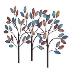 three metal trees with colorful leaves on them