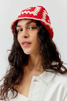 a woman wearing a red and white crocheted hat