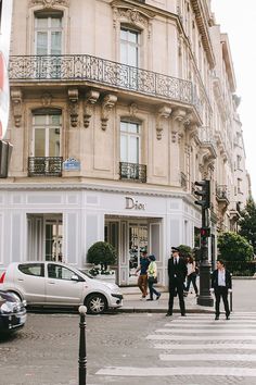 people crossing the street in front of a building