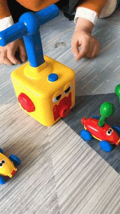 two children playing with toys on the floor