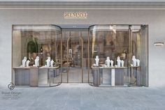 the front entrance to a jewelry store with mannequins on display in glass doors