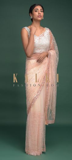 Buy Online from the link below. We ship worldwide (Free Shipping over US$100)  Click Anywhere to Tag Parchment White Saree In Net With Pink Thread, Beads And Sequins Work Striped Pattern Online - Kalki Fashion Parchment white saree in net with pink thread, beads and sequins embroidered striped pattern.Paired with a matching unstitched blouse with thread and sequins embroidery. Ruffle Saree Blouse, Sari Pink, Lehenga Style Saree, Thread Beads, Pink Thread, Ruffle Saree, Lehenga Style, White Saree