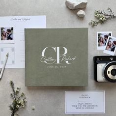 the wedding album is surrounded by photos, cards and other personalized items including a camera