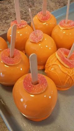 orange cake pops with pink sprinkles on them