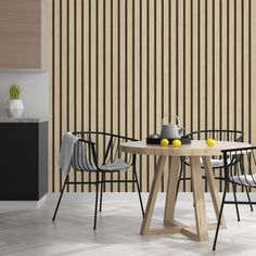 a dining table with chairs around it in front of a wall that has vertical stripes on it