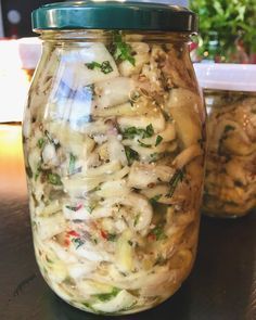 two jars filled with food sitting on top of a table