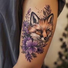 a woman's arm with a fox and flowers tattoo on it