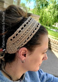 a woman wearing a crochet headband on top of her head and looking off into the distance