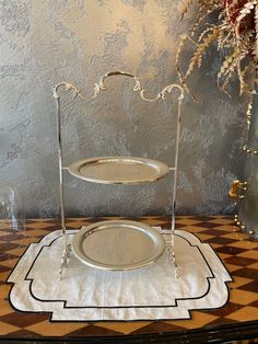 two tiered serving trays sitting on top of a table