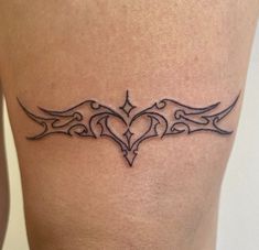 a woman's thigh with a tattoo design on it