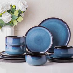 blue dishes and cups are sitting on a table