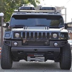 a black hummer is parked on the street