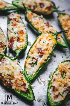 stuffed jalapenos with cheese and other toppings on a baking sheet, ready to be eaten