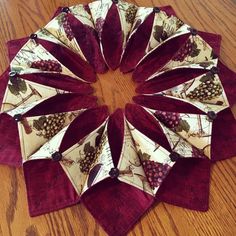 a close up of a paper plate on a wooden table with red and white napkins