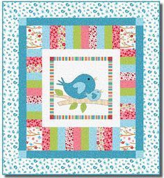 a blue bird sitting on top of a patchwork quilted wall hanging from a wooden frame