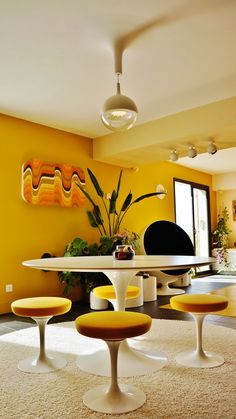 an image of a living room setting with yellow walls and white carpeted flooring