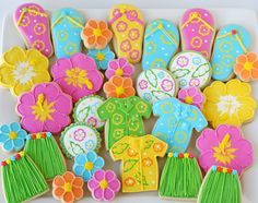 decorated cookies on a plate with flowers and sandals