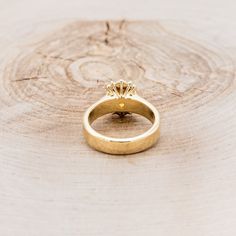 a yellow gold ring with a diamond on it