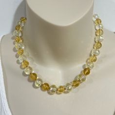 Bring some sparkle and sunshine to any look with this citrine and clear crystal collar necklace. This piece features citrine and clear faceted crystal beads alternating with gold plated brass beads. 8mm citrine 10mm clear faceted crystal length: 16.5" hook closure Handmade in Lincoln, Nebraska Yellow Citrine Jewelry With Faceted Beads, Gold Crystal Necklaces With Faceted Beads, Citrine Faceted Round Beads Jewelry, Faceted Citrine Beads Jewelry, Citrine Jewelry With Faceted Round Beads, Elegant Faceted Amber Crystal Necklaces, Gold Necklace With Crystal And Gemstone Beads, Elegant Amber Faceted Crystal Necklace, Elegant Faceted Amber Crystal Necklace