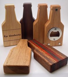 several wooden objects are arranged on a white surface, including one with a bottle opener