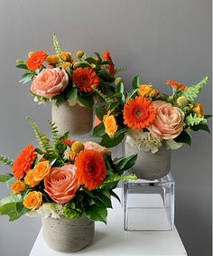 three vases filled with different types of flowers