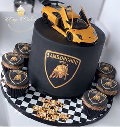 a black cake with yellow cupcakes and a lamb car on top that says lamborgchinn