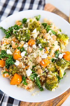 a white plate topped with broccoli, carrots and cauliflower rice