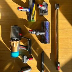 several different types of household appliances on a wooden floor with sunlight coming through the window