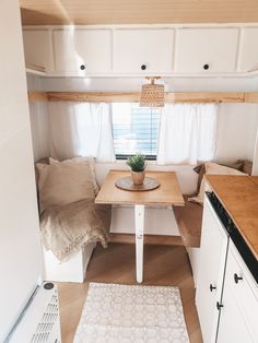 a kitchen area with a table, sink and stove