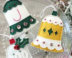 three christmas ornaments sitting on top of a glass plate