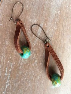 pair of earrings with brown leather and green beads