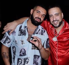 two men standing next to each other at a party