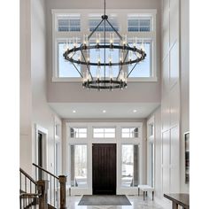 a chandelier hanging from the ceiling in a foyer