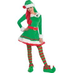 a woman dressed in green and red is standing with her hands on her hips while wearing an elf costume