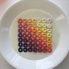 a white plate topped with lots of colorful beads