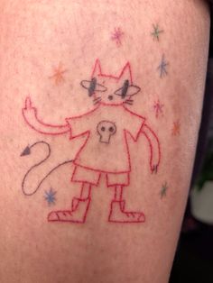 a person with a cat tattoo on their leg