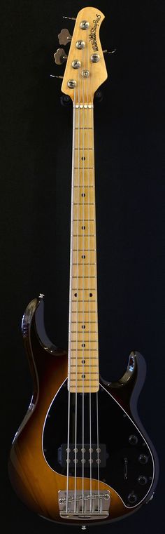 an electric bass guitar is shown against a black background