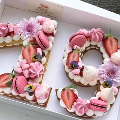 a cake in the shape of the number 50 decorated with strawberries and flowers