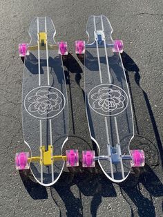 two skateboards sitting on top of each other in the middle of the street with wheels