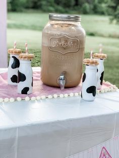 a table topped with two mason jars filled with milk