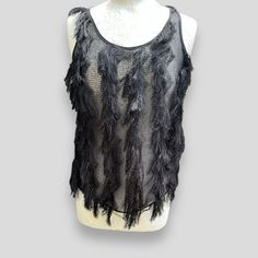 Elevate your wardrobe with this elegant and designer French connection top. The black sleeveless tank top features a scoop neck and pullover closure. The panelled mesh fabric with fringe accents adds a touch of sophistication to the look. Ideal for both casual and party occasions, this lightweight and breathable top is a must-have for any fashion-forward woman's collection. Available in size S, this regular fit top is perfect for any season - Summer and Autumn. Please take a moment to study imag Sheer Sleeveless Top For Night Out, Spring Party Tank Top With Fringe, Sheer Mesh Tank Top For Party, Sheer Mesh Tank Top For Night Out, Mesh Tank Top For Night Out, Fitted Sleeveless Fringe Tank Top, Fitted Sleeveless Tank Top With Fringe, Black Sleeveless Sheer Mesh Top, Black Sheer Sleeveless Mesh Top