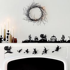 a fireplace with candles and decorations on it