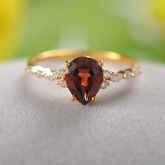 a close up view of a ring with an orange stone